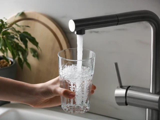 water running from a tap into a glass